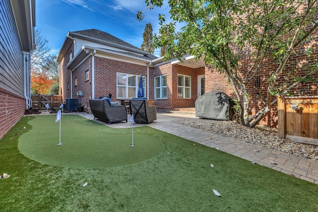 rear view of house featuring central AC and a patio area