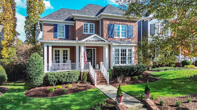 view of front of home with a porch and a front lawn