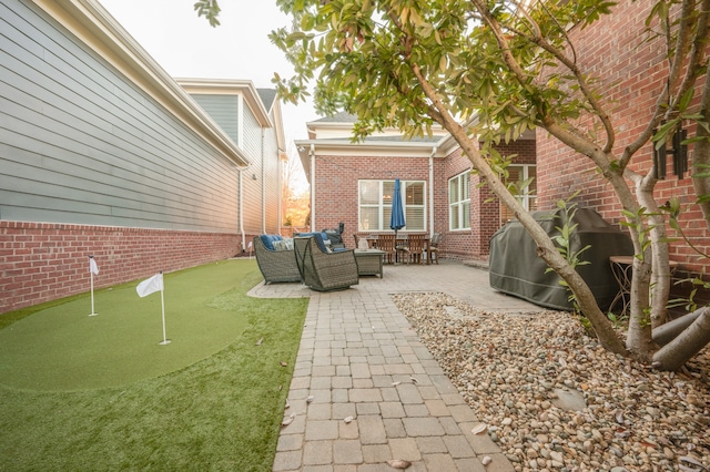 view of patio / terrace featuring outdoor lounge area and a grill