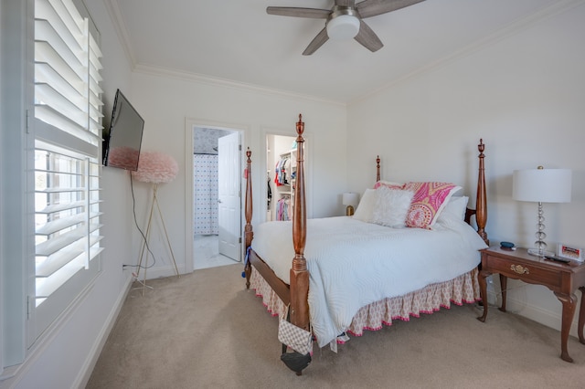 bedroom with connected bathroom, ceiling fan, light colored carpet, a walk in closet, and ornamental molding