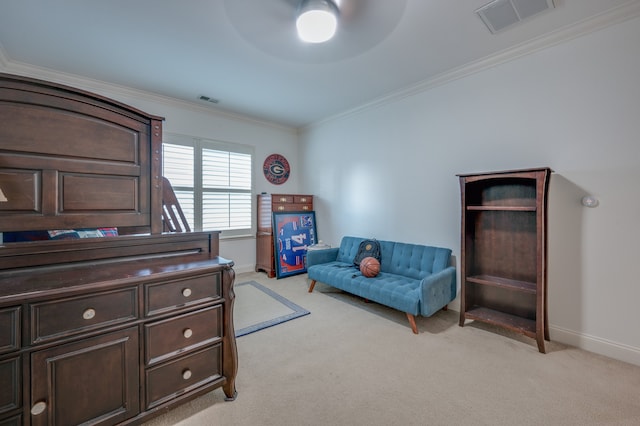 sitting room featuring ceiling fan, light colored carpet, and ornamental molding