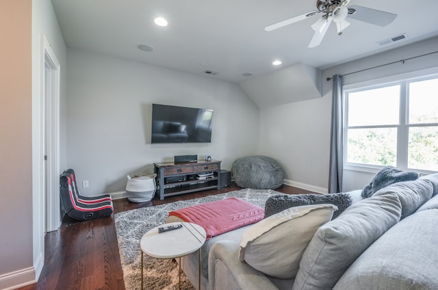 living room featuring ceiling fan and dark hardwood / wood-style floors