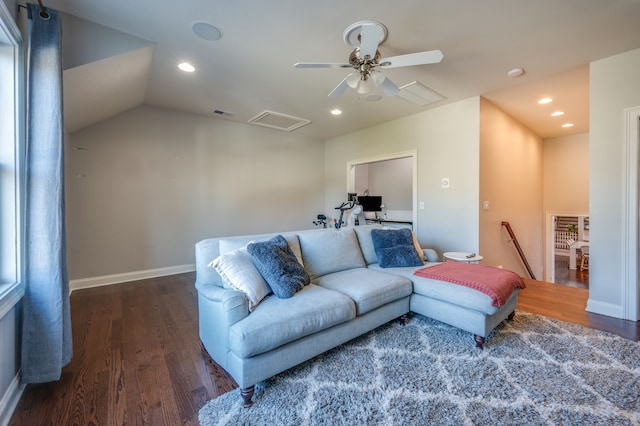 living room with ceiling fan, dark hardwood / wood-style flooring, and vaulted ceiling