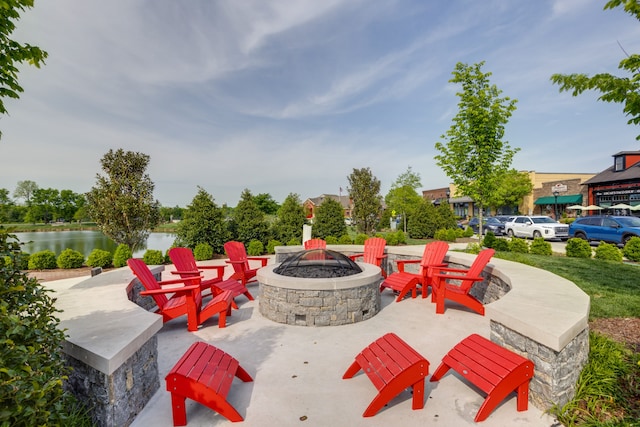 view of patio / terrace featuring a water view and an outdoor fire pit