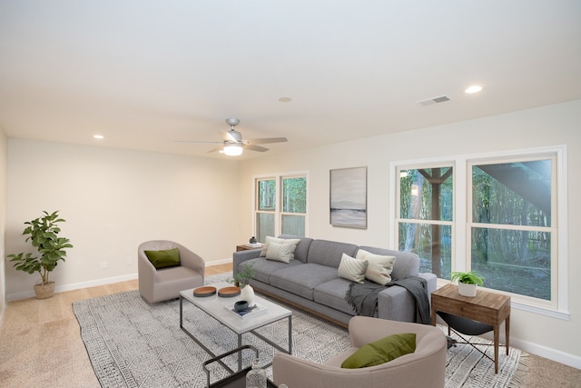 carpeted living room featuring ceiling fan