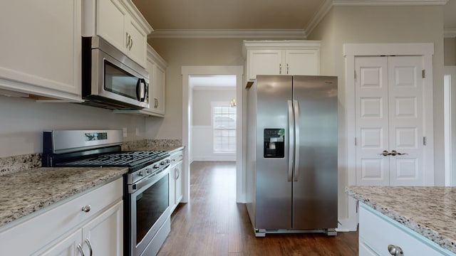 kitchen with white cabinets, dark hardwood / wood-style floors, crown molding, and stainless steel appliances