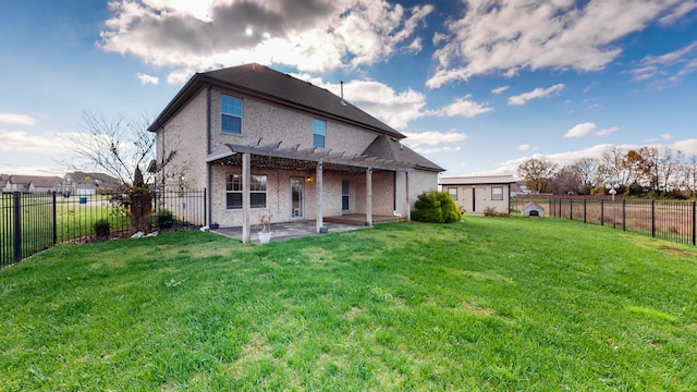 rear view of property featuring a pergola, a patio area, and a yard