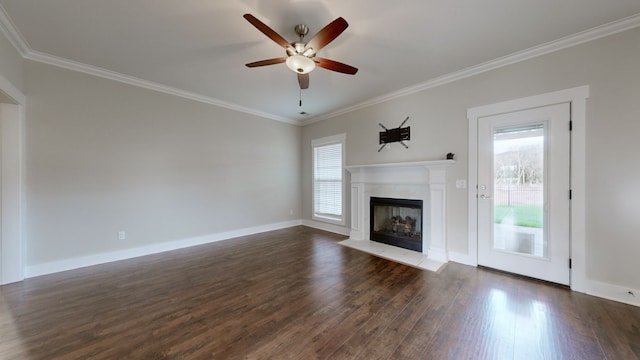 unfurnished living room featuring dark hardwood / wood-style floors, a healthy amount of sunlight, ornamental molding, and ceiling fan