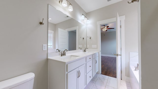 bathroom with a tub to relax in, vanity, ceiling fan, hardwood / wood-style floors, and toilet