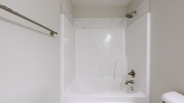 bathroom featuring toilet and shower / bathtub combination