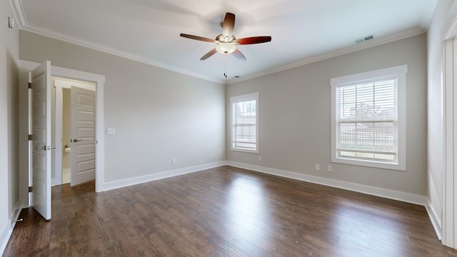 empty room featuring a wealth of natural light, crown molding, ceiling fan, and dark hardwood / wood-style floors