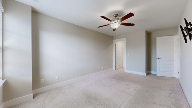 unfurnished bedroom with ceiling fan and light colored carpet