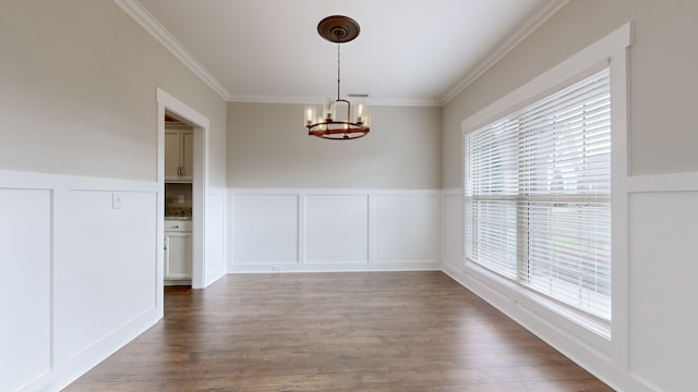 unfurnished dining area with plenty of natural light, dark hardwood / wood-style flooring, and a chandelier