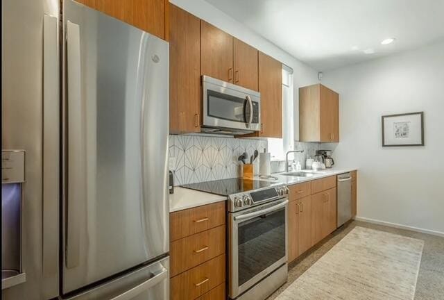 kitchen featuring tasteful backsplash, sink, and stainless steel appliances