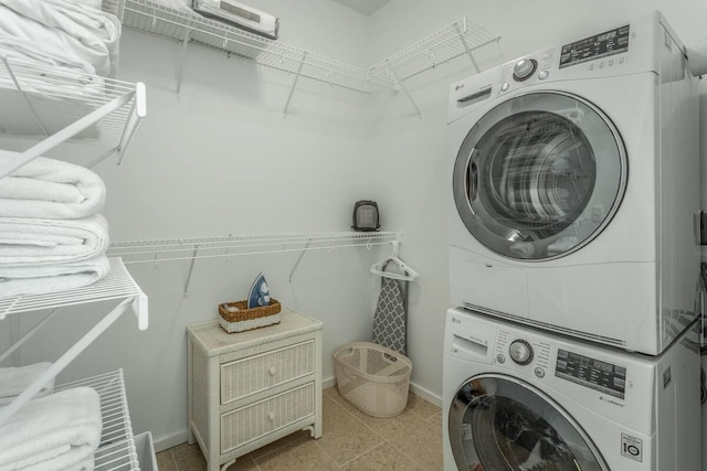 clothes washing area with stacked washing maching and dryer