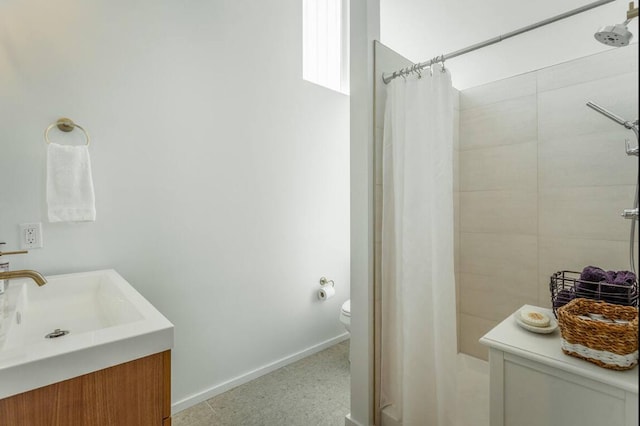 bathroom featuring vanity, toilet, and curtained shower