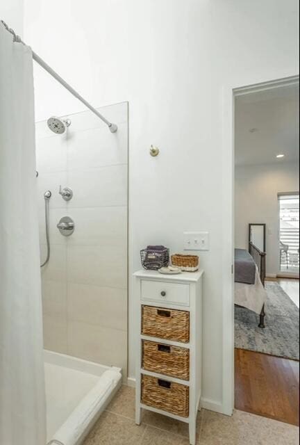 bathroom featuring hardwood / wood-style flooring and curtained shower