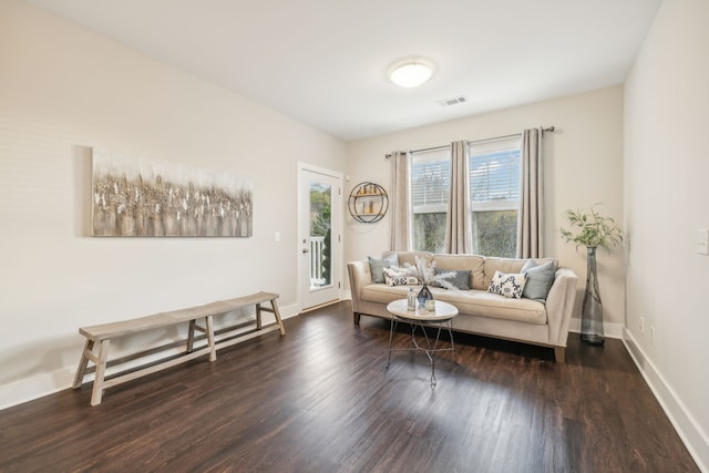 sitting room with dark wood-type flooring