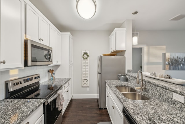 kitchen with dark hardwood / wood-style flooring, white cabinetry, sink, and appliances with stainless steel finishes