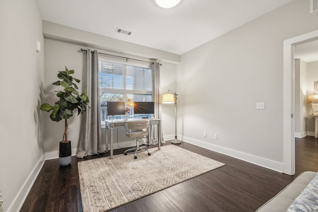 home office with dark hardwood / wood-style floors