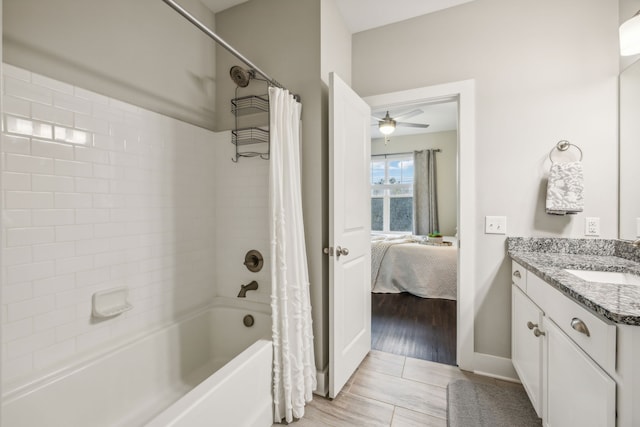 bathroom with hardwood / wood-style flooring, vanity, ceiling fan, and shower / bath combo with shower curtain