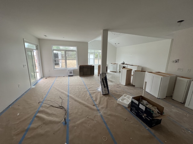 living room featuring lofted ceiling