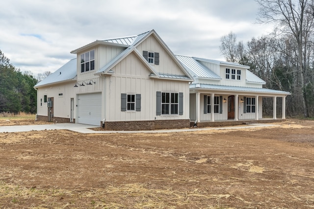 view of front of property featuring covered porch and a garage