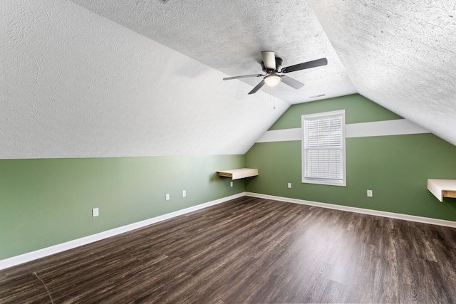 bonus room featuring vaulted ceiling, ceiling fan, wood-type flooring, and a textured ceiling