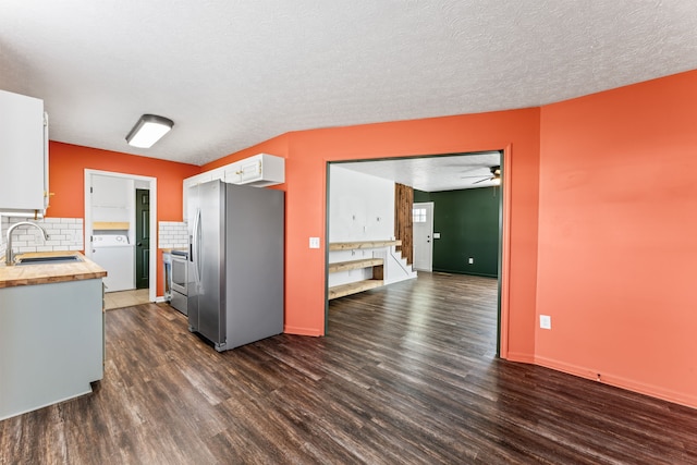 kitchen featuring stainless steel appliances, sink, white cabinets, washer / clothes dryer, and dark hardwood / wood-style floors