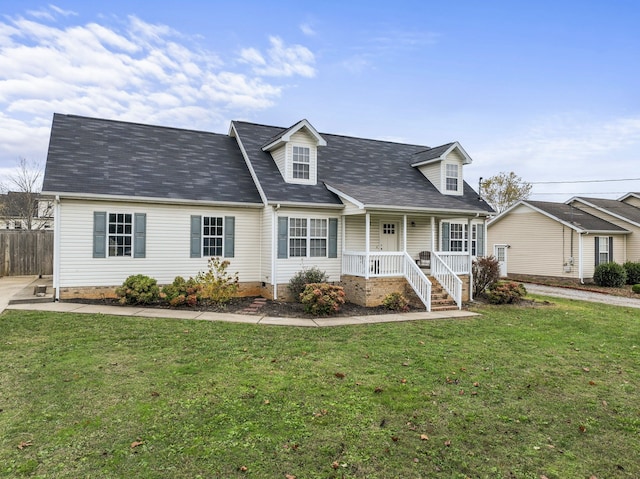 cape cod house featuring covered porch and a front yard