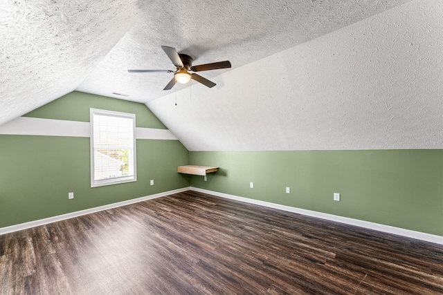 bonus room featuring a textured ceiling, dark hardwood / wood-style floors, ceiling fan, and lofted ceiling