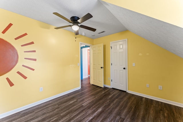 additional living space featuring a textured ceiling, ceiling fan, dark hardwood / wood-style flooring, and lofted ceiling