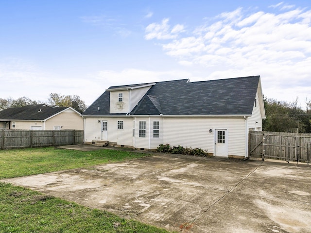 rear view of property with a lawn and a patio area