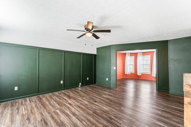 interior space with a textured ceiling, ceiling fan, a closet, and dark hardwood / wood-style floors