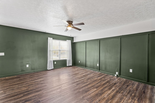 unfurnished bedroom with a textured ceiling, ceiling fan, a closet, and dark hardwood / wood-style floors