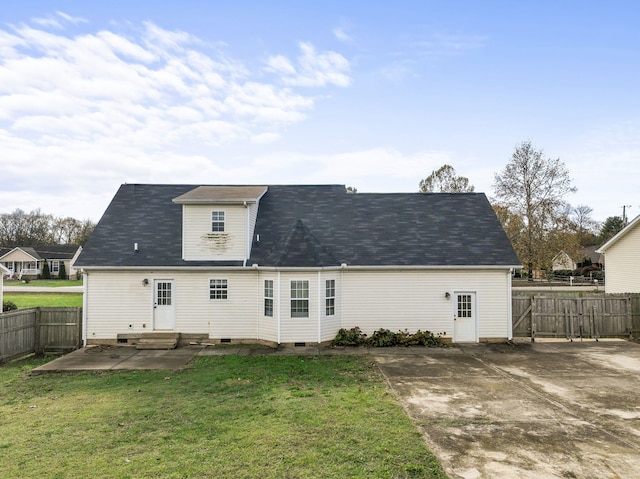 rear view of house featuring a patio area and a yard