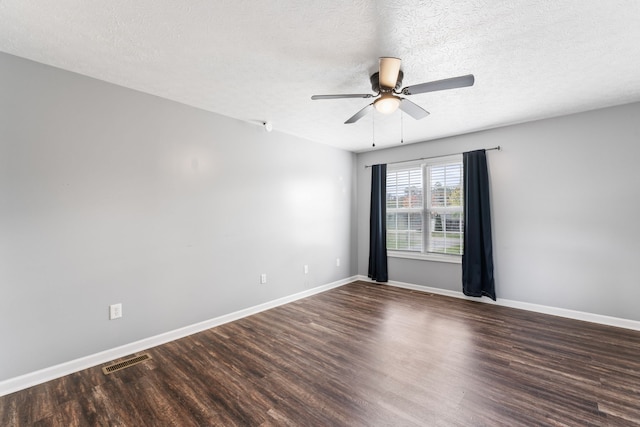 unfurnished room with a textured ceiling, ceiling fan, and dark wood-type flooring