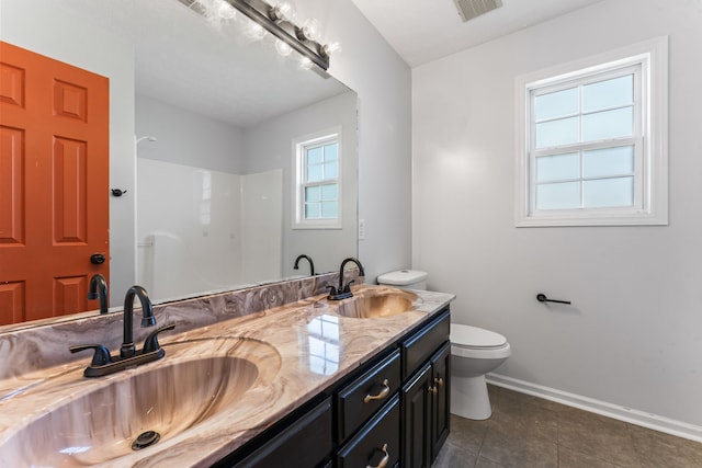 bathroom with tile patterned floors, vanity, and toilet