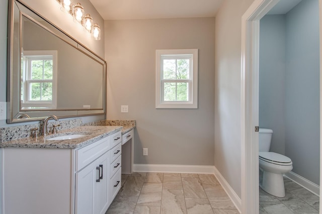 11B Double Br, Columbia, TN 38401 - bathroom featuring marble look tile flooring, vanity, healthy amount of natural light, and toilet