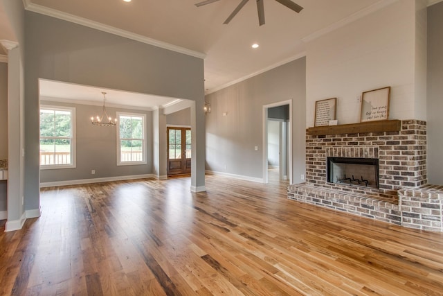 11B Double Br, Columbia, TN 38401 - unfurnished living room featuring crown molding, wood finished floors, ceiling fan, a fireplace, and a chandelier