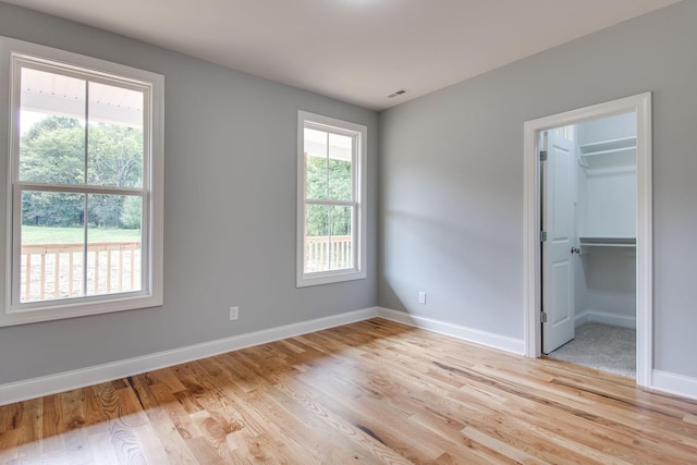 11B Double Br, Columbia, TN 38401 - unfurnished bedroom with light wood-type flooring, baseboards, and a walk in closet
