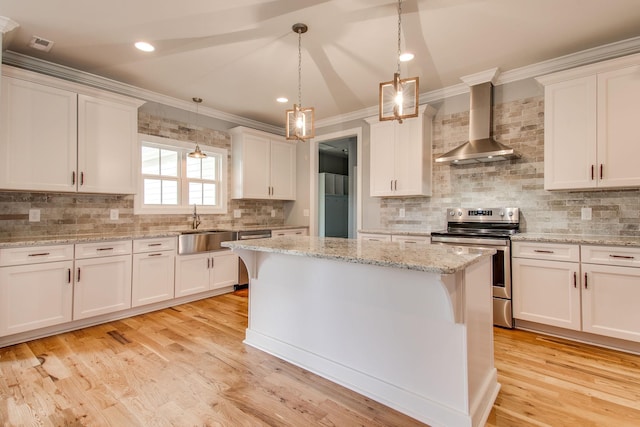 11B Double Br, Columbia, TN 38401 - kitchen featuring wall chimney exhaust hood, appliances with stainless steel finishes, crown molding, tasteful backsplash, and a kitchen island