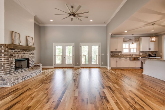 11B Double Br, Columbia, TN 38401 - unfurnished living room featuring a fireplace, light wood finished floors, ceiling fan, ornamental molding, and recessed lighting
