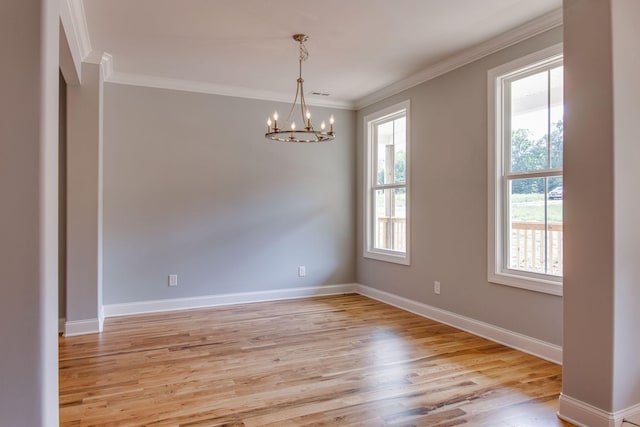 11B Double Br, Columbia, TN 38401 - spare room featuring healthy amount of natural light, a chandelier, light wood-style flooring, ornamental molding, and baseboards