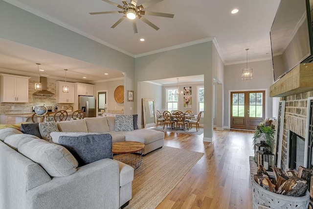 11B Double Br, Columbia, TN 38401 - living area with light wood-type flooring, a stone fireplace, ceiling fan, recessed lighting, and crown molding