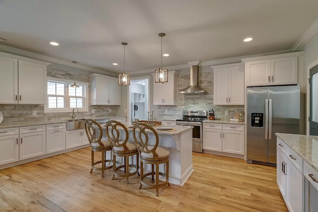 11B Double Br, Columbia, TN 38401 - kitchen featuring stainless steel appliances, wall chimney exhaust hood, ornamental molding, white cabinetry, and tasteful backsplash