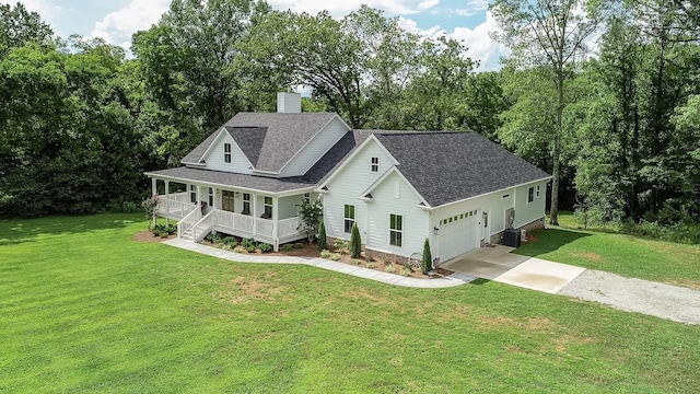 view of front facade with central AC, a front lawn, covered porch, and a garage