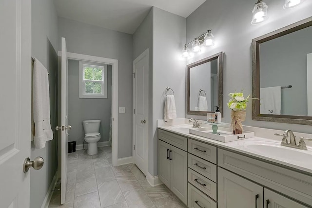 11B Double Br, Columbia, TN 38401 - bathroom featuring double vanity, marble look tile flooring, toilet, and baseboards