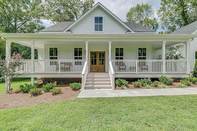 country-style home with covered porch and a front yard