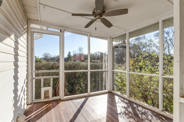 unfurnished sunroom with ceiling fan